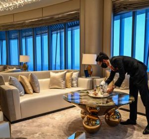 An employee is seen in a suite room of the J Hotel, the world's highest luxury hotel, boasting a restaurant on the 120th floor and 24-hour personal butler service, located in the Shanghai Tower, in Shanghai on June 23, 2021. (Photo by Hector RETAMAL / AFP) (Photo by HECTOR RETAMAL/AFP via Getty Images)