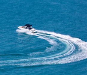 Recreational high speed motorboat makes sudden turn at sea
